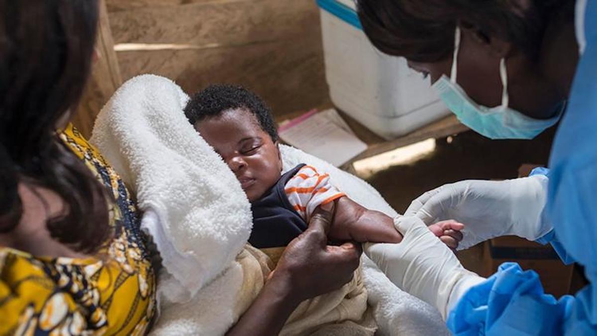 A nurse prepares to vaccinate an infant in North Kivu province, Democratic Republic of the Congo.