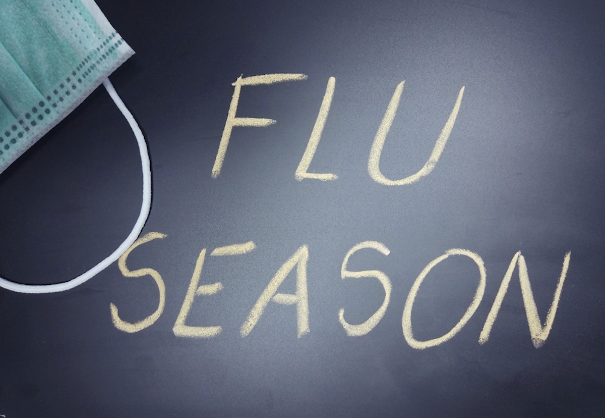flu season written on black chalkboard