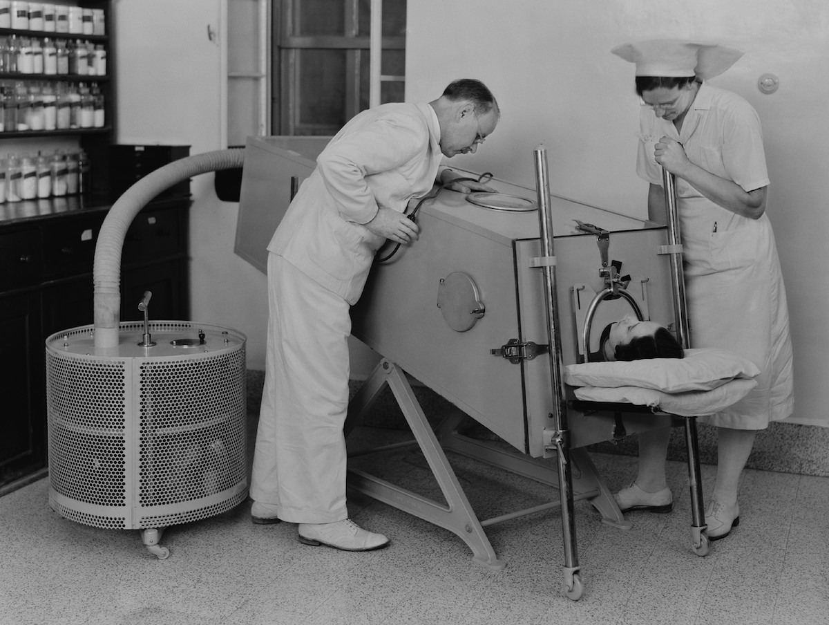 Polio patient in an iron lung at the Scots Mission Hospital in Tiberias, Palestine in March 1940. When polio weakened muscles used in breathing, an iron lung assisted respiration.