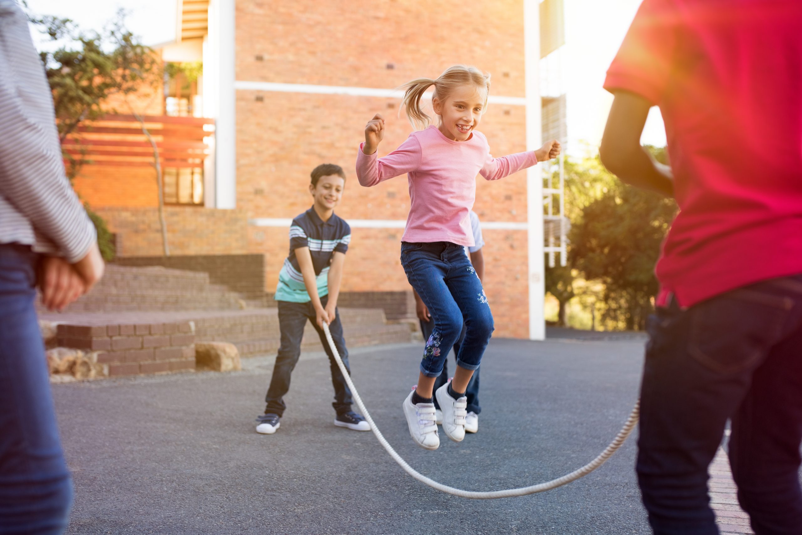 Young girl playing jump rope