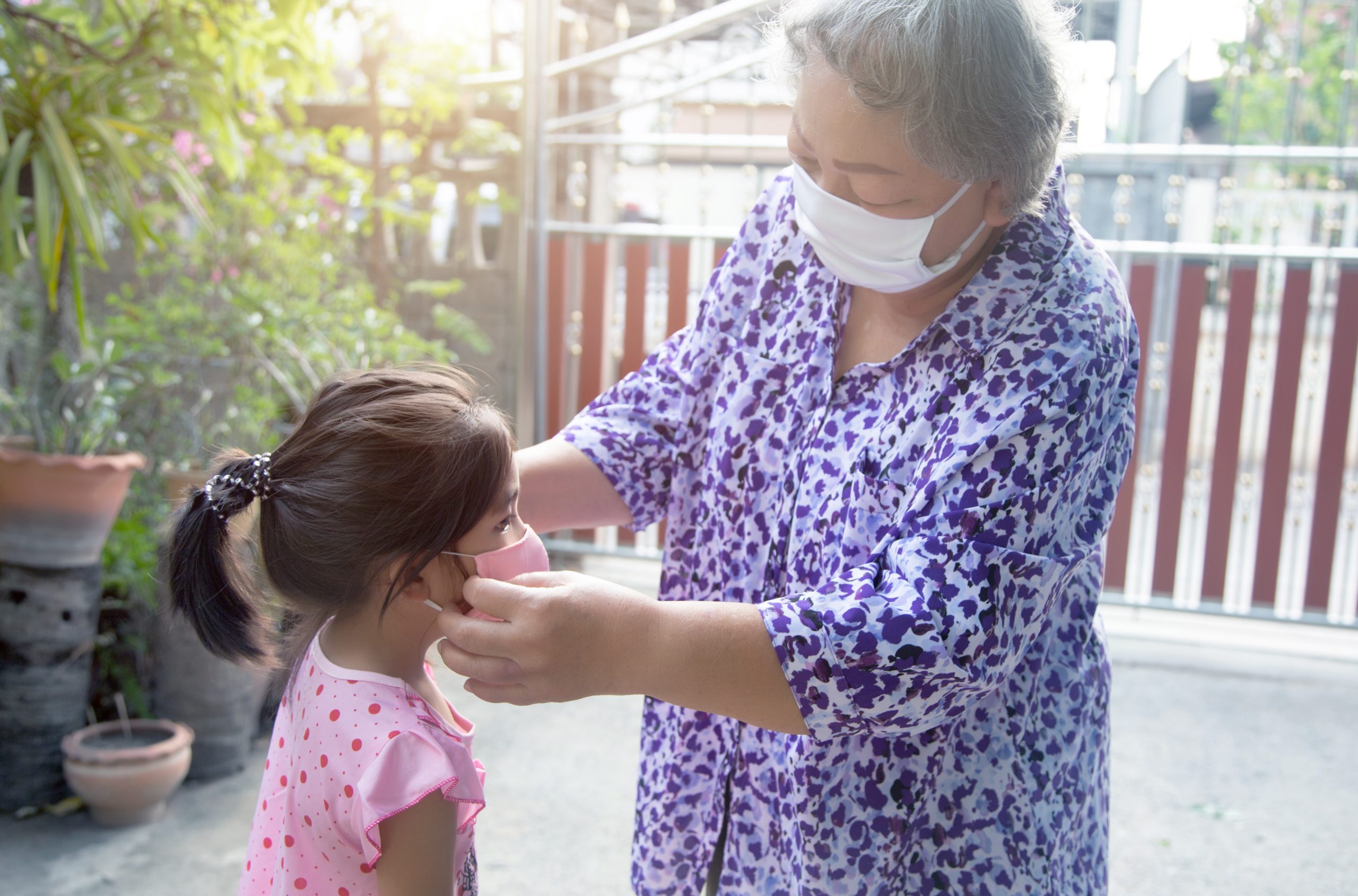 grandparent face mask to kids for protect corona virus pandemic before go outside home. alway use medical mask for protect coronavirus pandemic for family health care for nursery human from virus