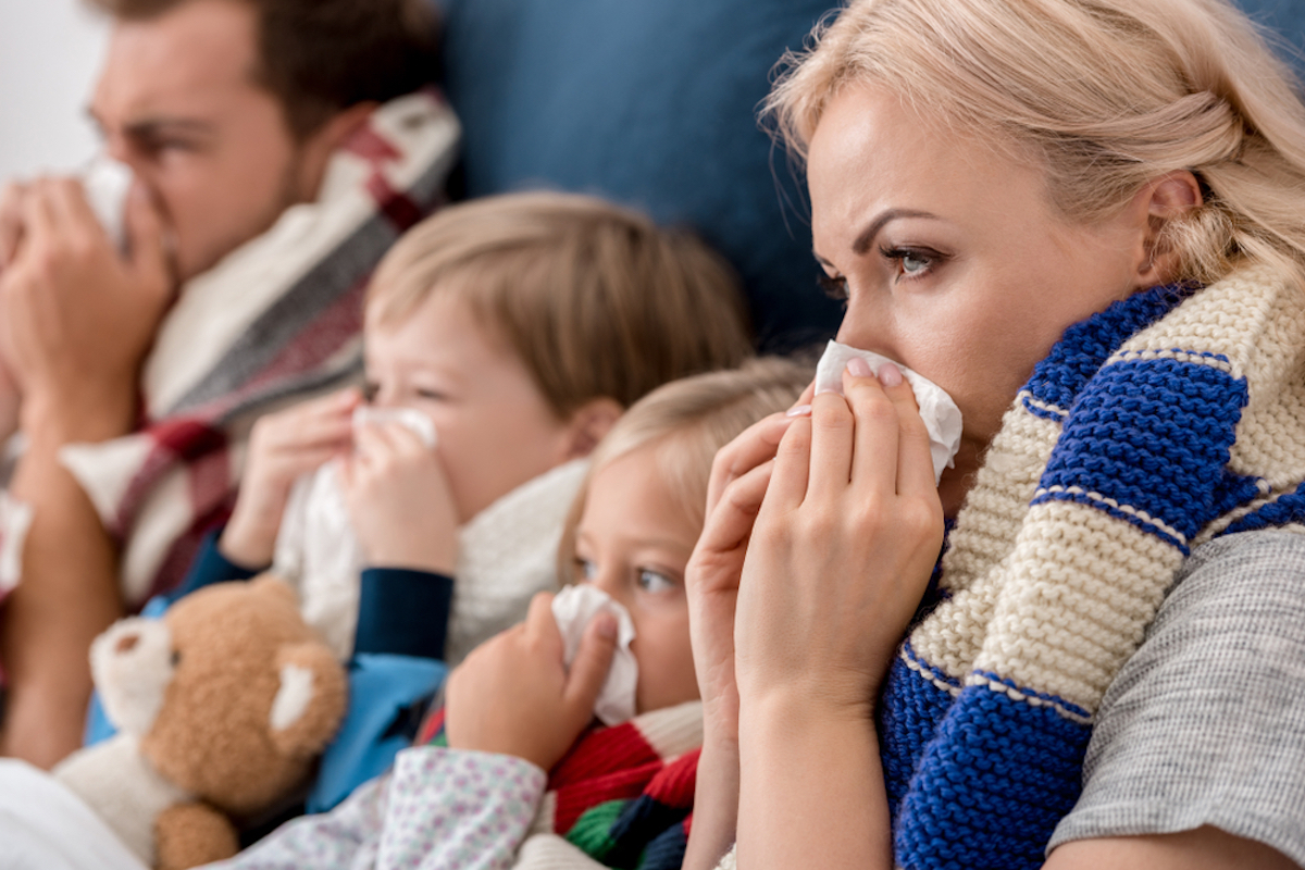 sick family with flu blowing their noses