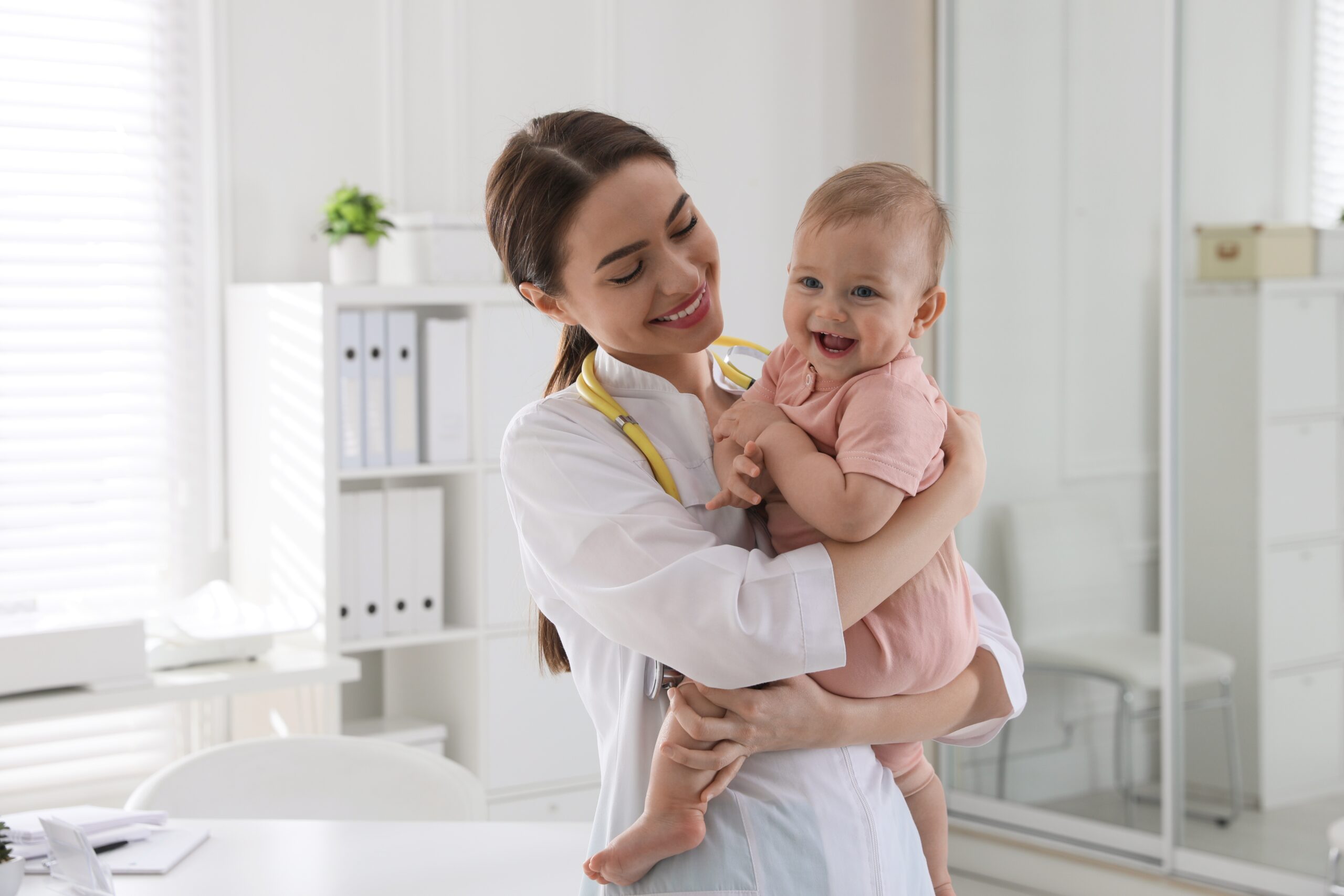 Pediatrician holding a baby