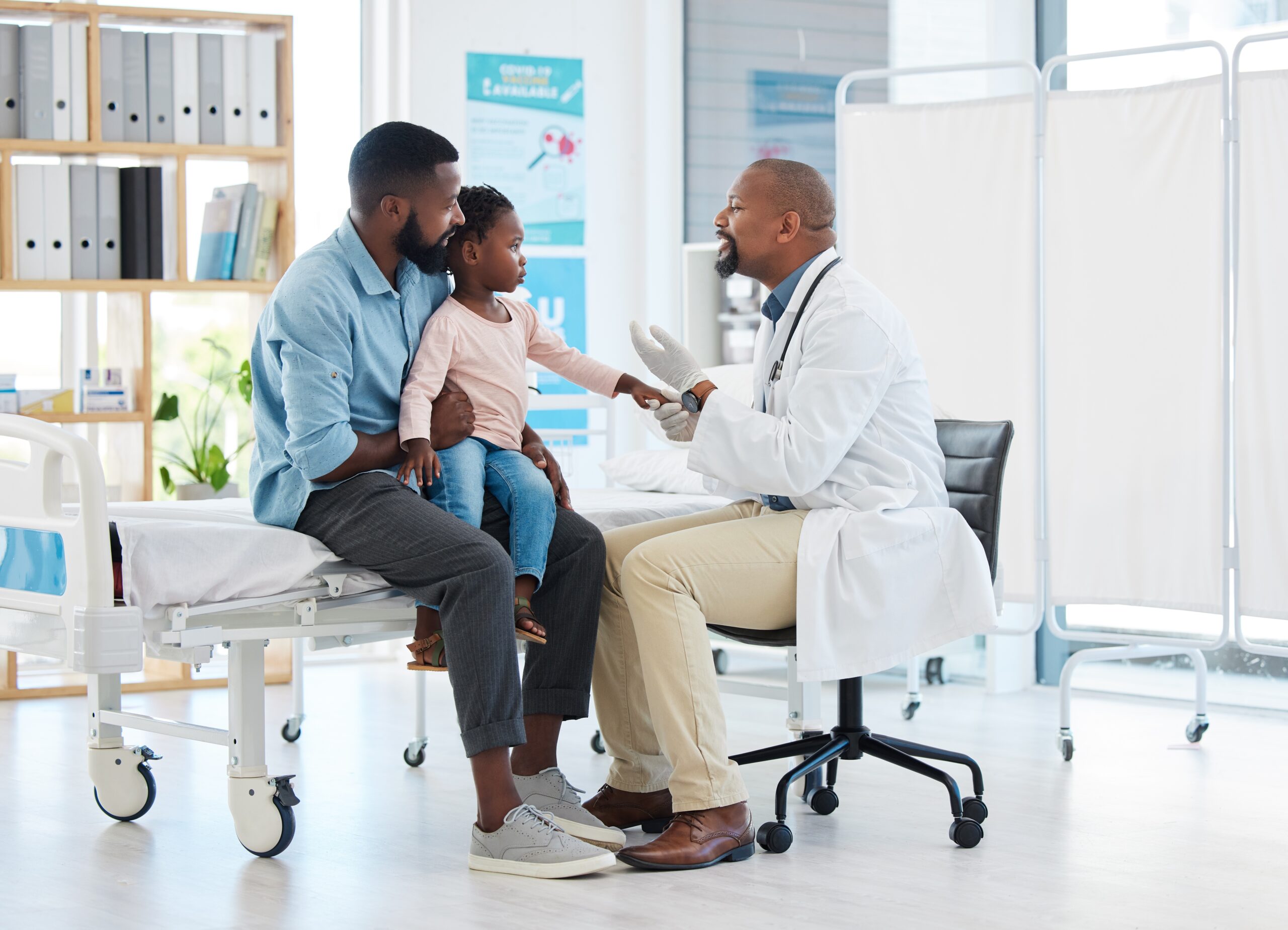 Doctor talking with father and child