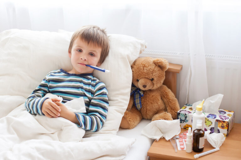 Child sick in bed with a fever