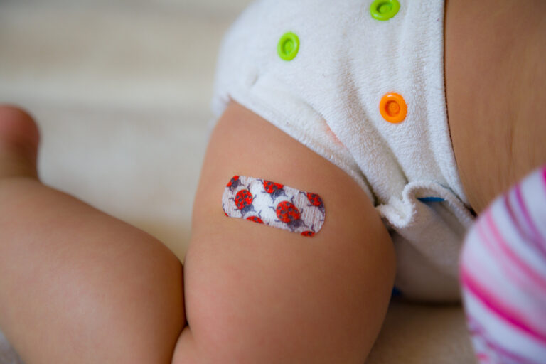 Baby's bandaid over vaccination