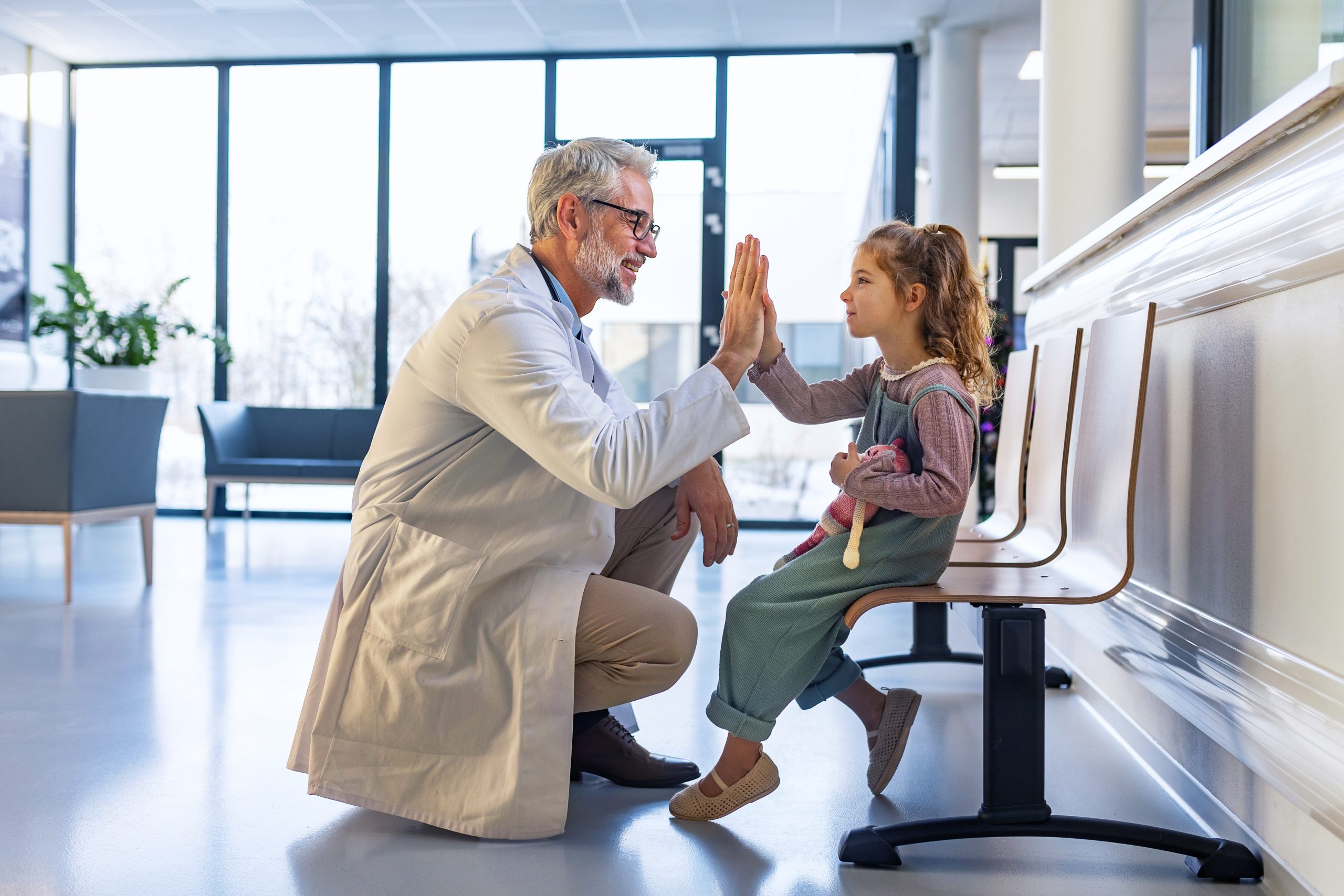 Young girl giving a doctor a high five